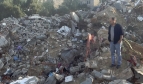 Saad Ismail standing in the ruins of the family home where six family members were killed