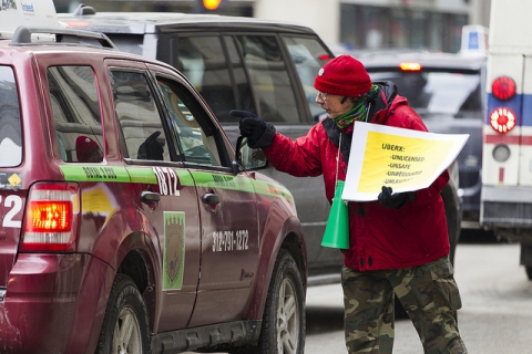 Taxi drivers have a discussion in the street during a protest over Uber outside City Hall in Chicago