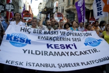 Turkish trade union demonstrators holding a flag