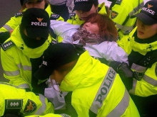 Police removing striking worker from sit-in