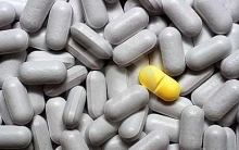 one yellow pill among many grey ones