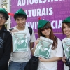Four people with Robin Hood Tax hats and posters