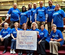 Group of AFT members holiding banner supporting the UN workers