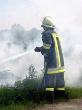Firefighter using water hose