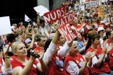Nurses demonstrating. Banner says "Nurse ratios save lives"