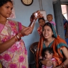 Health worker in India prepares to vaccinate baby